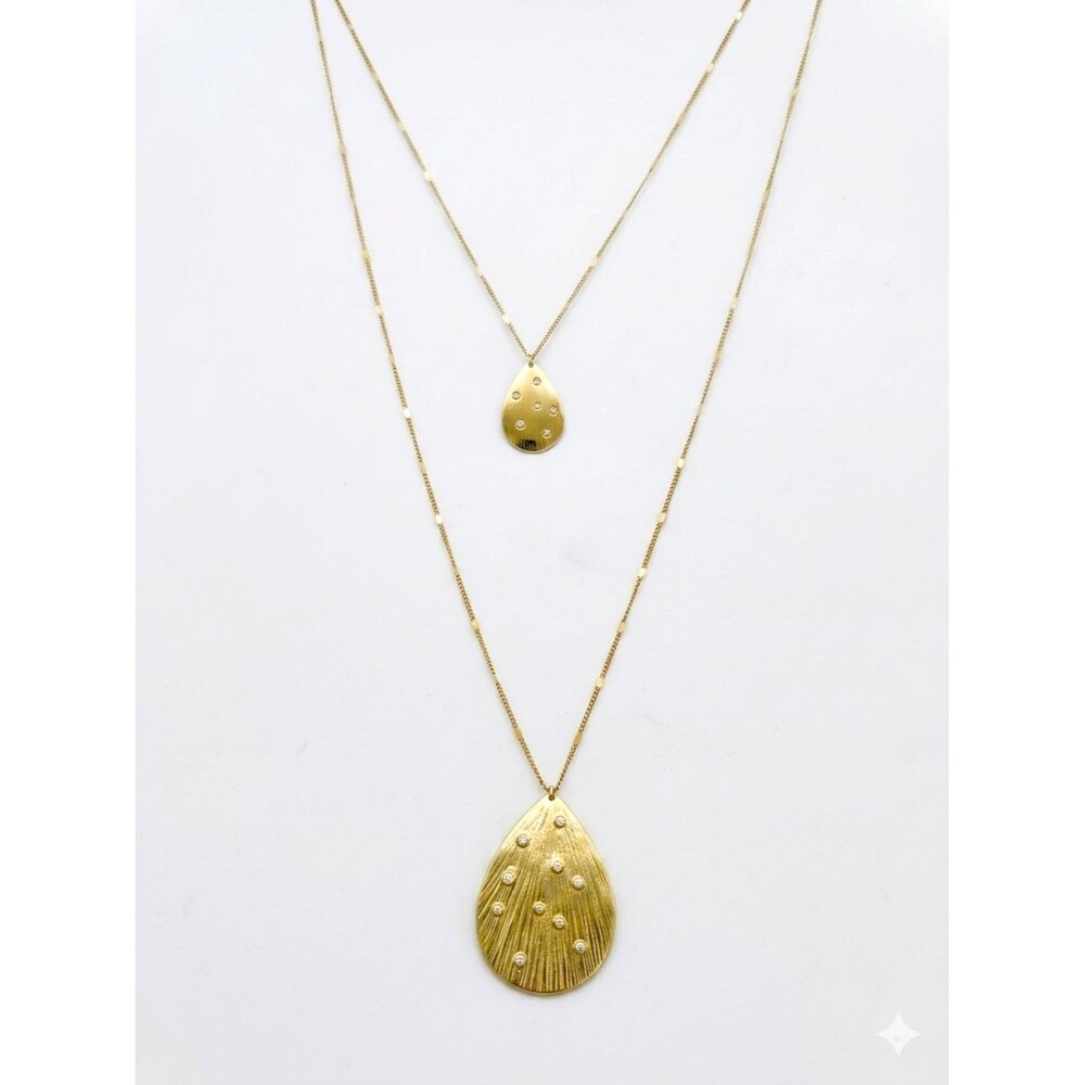 Chic gold-tone multi-strand layered necklace featuring two textured teardrop